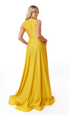 A woman in the Cut-Out Long A-Line Prom Dress: Atria 6706H, a floor-length sleeveless yellow gown, stands facing away against a white background.