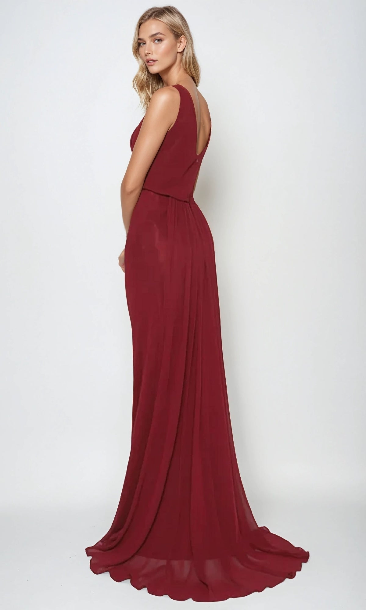 A woman poses against a plain background in the Long Prom Dress: Juliet 670—a floor-length, deep red gown featuring a sleeveless fitted bodice and a flowing skirt.