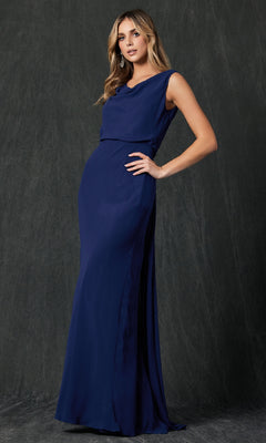 A woman poses against a dark textured background in the Juliet 670 Long Prom Dress, a floor-length dark blue gown with a sleeveless design and cowl neckline that drapes elegantly.