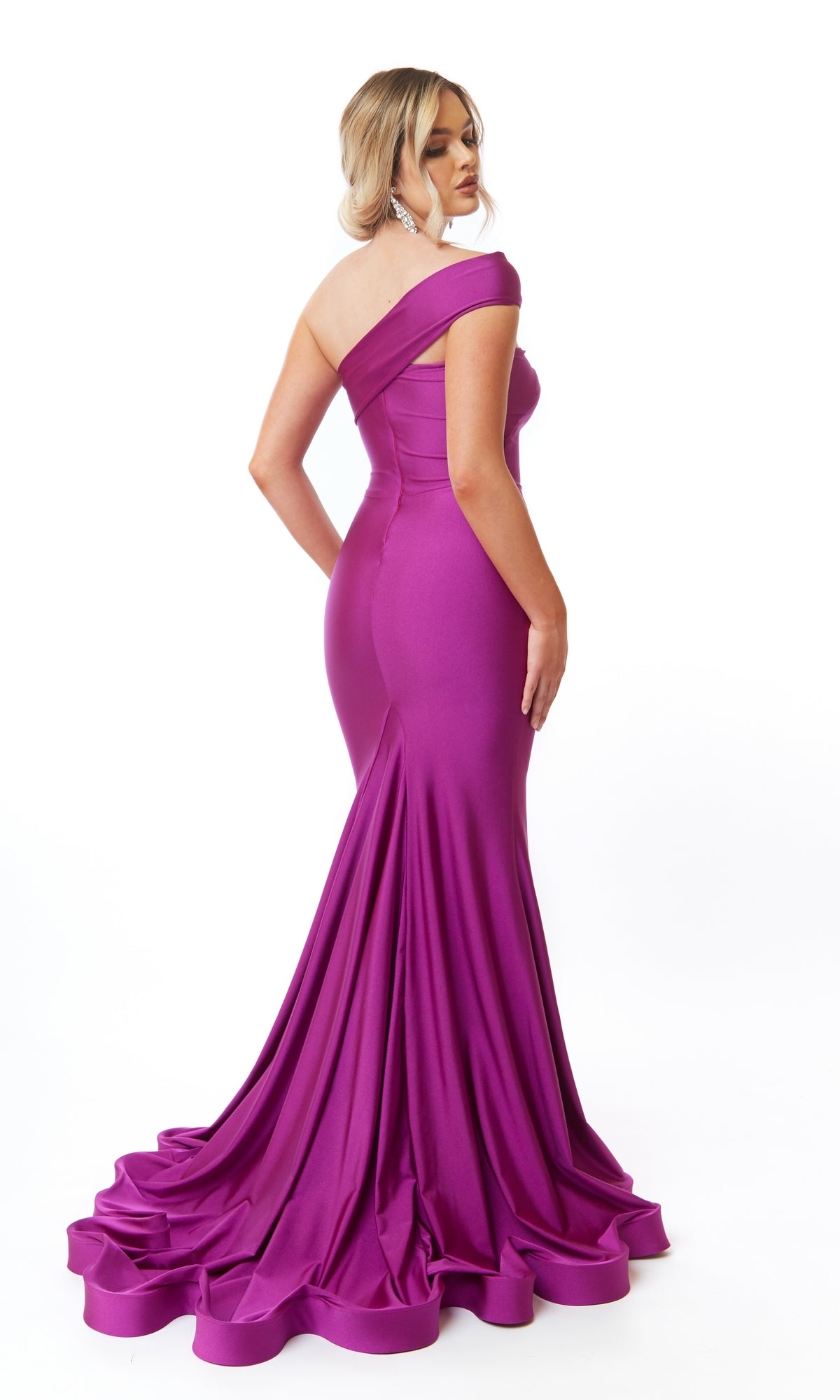 A woman captivates in the Atria 6713H One-Shoulder Long Mermaid Prom Dress, featuring a fitted silhouette and dramatic flared train, set against a white background.