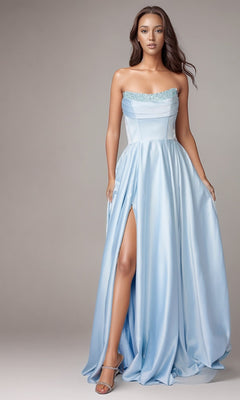 A woman in a strapless baby blue Nina Canacci 6718 long formal dress with a thigh-high slit and silver heels stands against a plain background.