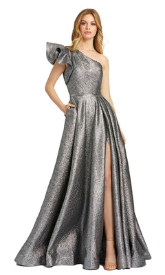 A woman stands elegantly against a white background wearing the Mac Duggal 67297 Metallic Long Prom Ball Gown, featuring a one-shoulder design, ruffled sleeve, high slit, and side pockets.