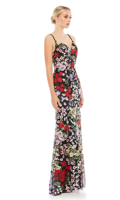 A woman models the Mac Duggal 67473 Long Floral Formal Dress—a sleeveless, floor-length gown with spaghetti straps, fitted bodice, and flared hem—posing slightly sideways against a white background.