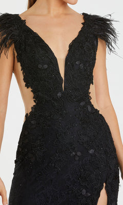 A woman wearing the Mac Duggal 67782 Black Embroidered Formal Gown—a long, sleeveless black dress with a deep V-neckline, feathered shoulder accents, and intricate floral appliqué detailing.