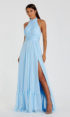 A woman wears the Mac Duggal 67816 Open-Back Halter Formal Dress, a sleeveless light blue gown with a high slit, gathered bodice, and floor-length skirt, posed against a plain white background.