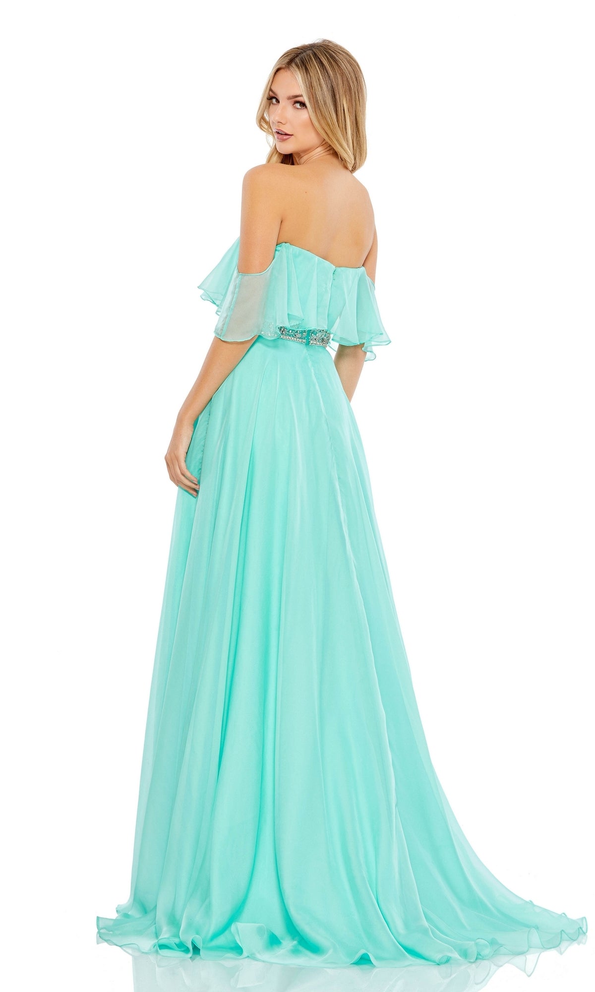 Woman in a light blue Beaded-Waist Off-Shoulder Long Prom Dress 67817 with a flowing skirt, glancing over her shoulder against a white background.