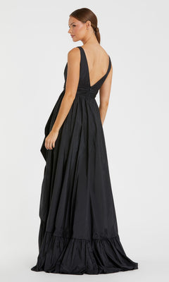 Woman wearing the Mac Duggal 67835 Long Ruffled Formal Dress, a sleeveless black floor-length gown with a V-back, standing and looking to the side against a plain white background.