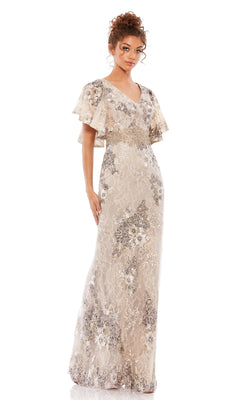 A woman wears the Mac Duggal 67842 Flutter-Sleeve Long Formal Dress in light beige, featuring floral lace patterns and sequin embellishments, standing against a plain white background.