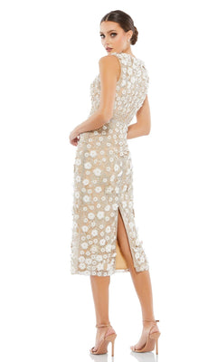 A woman in the Mac Duggal 67853 knee-length party dress with floral embroidery, sleeveless design, and back slit poses in nude high-heeled sandals against a white background.