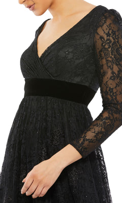 Someone wearing the Mac Duggal 67861 Long Black Lace Formal Dress featuring a V-neckline, velvet waistband, and floral lace—an elegant evening gown ideal for special occasions.