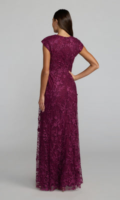 Woman with back to camera wears the Cap Sleeve Long Blue Formal Gown: Mac Duggal 67882—a stunning floor-length blue dress with cap sleeves, perfect for formal occasions.