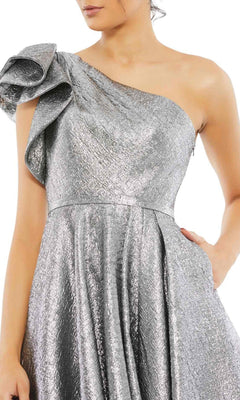 A woman in the Mac Duggal 67906 metallic short wedding-guest dress, featuring a one-shoulder design, textured pattern, and ruffled sleeve—a striking knee-length choice for special events.