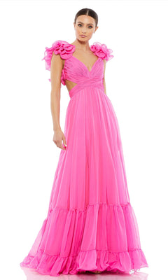 A woman models the Mac Duggal Empire-Waist Cut-Out Formal Dress 67911 in bright pink, featuring ruffled sleeves and floral shoulder accents, posed against a white background.