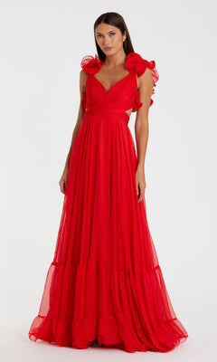 A woman poses against a white background wearing the Mac Duggal Empire-Waist Cut-Out Formal Dress 67911, a floor-length red sleeveless gown with ruffled shoulders, looking directly at the camera.