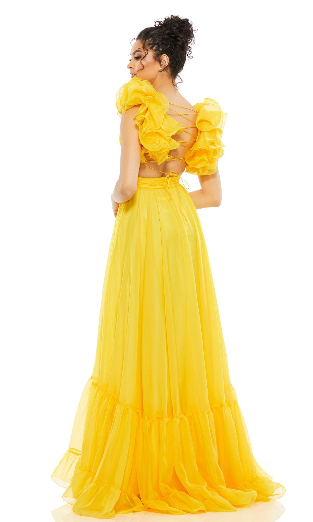 A woman faces away, wearing the Mac Duggal Empire-Waist Cut-Out Formal Dress 67911, a long, bright yellow gown with ruffled sleeves and a crisscross back detail.
