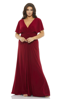 A woman wears the Long Plus-Size Prom Dress 67916 by Mac Duggal, a floor-length deep red gown with short flutter sleeves and a V-neckline, standing against a plain white background.