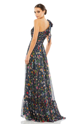 Model in the Long Navy Print Prom Gown Mac Duggal 67938, featuring a one-shoulder design and vibrant floral pattern, poses against a white background.