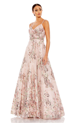 A woman stands slightly turned, wearing the Long Formal Dress 67971 by Mac Duggal—a floor-length, sleeveless gown in rose pink with floral patterns and sequin embellishments.