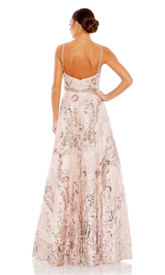 A woman stands with her back to the camera, wearing the Long Formal Dress 67971 by Mac Duggal—a rose pink ball gown with floral sequin patterns and thin straps.