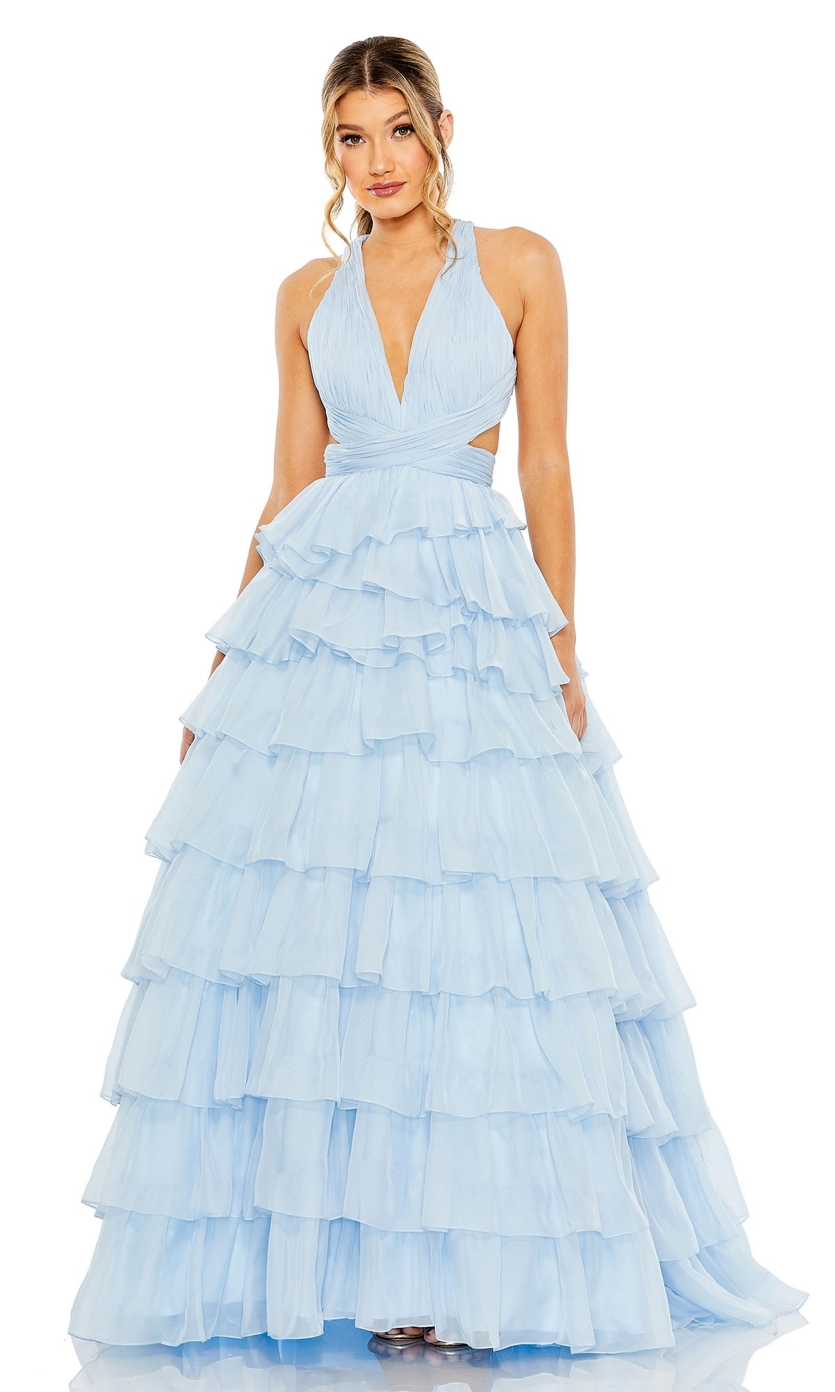 A woman stands facing forward in the Long Formal Dress 67988 by Mac Duggal, a sleeveless light blue A-line ball gown featuring a deep V-neckline and multi-layered ruffles.