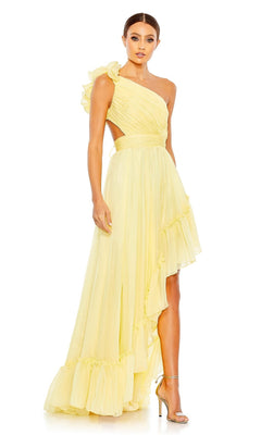 A woman wears the Long Formal Dress 67989 by Mac Duggal, featuring light yellow fabric, a one-shoulder design with ruffled details, and an asymmetrical hem, paired with strappy high heels against a plain background.