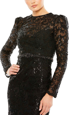 A person wearing the Mac Duggal 68011 Long Beaded-Lace Formal Dress, featuring black long sleeves, a fitted waist, sequin and lace detailing, and sheer accents on the sleeves and chest.