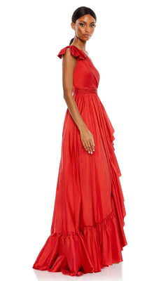 A woman poses in the Long Formal Dress 68027 by Mac Duggal, a sleeveless, floor-length red gown with draped detailing and a ruffled hem, facing slightly to the side against a plain white background.