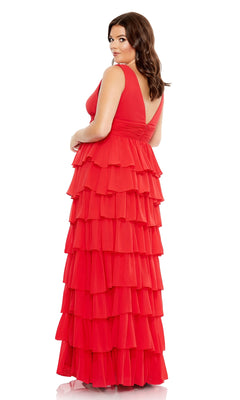 A woman poses against a white background in the Mac Duggal Long Plus-Size Formal Dress 68119, featuring a sleeveless, floor-length design with layered ruffles and a ruched empire waist.