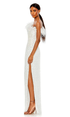 A woman stands in profile wearing the Feather One-Shoulder Formal Gown: Mac Duggal 68139, a white, floor-length dress featuring feather accents and a thigh-high slit, styled with nude heels.