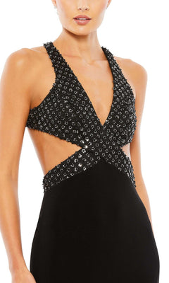 A woman wears the Long Formal Dress 68166 by Mac Duggal, featuring a fitted silhouette, deep V neckline, cutout sides, open back, and delicate silver embellishments.