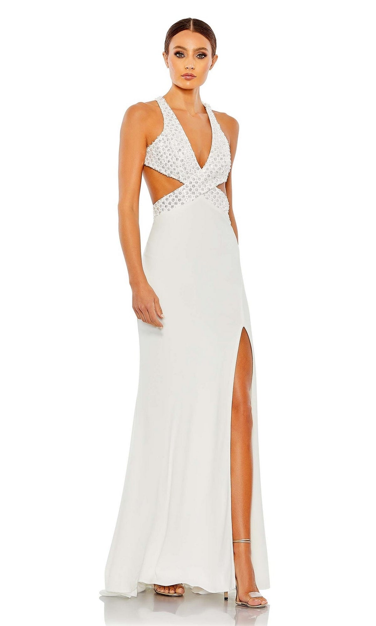 A woman wears the Mac Duggal Long Formal Dress 68166 featuring a deep v-neckline, side cutouts, open back, and high slit, standing against a plain white background.