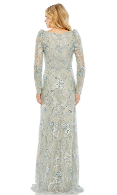 Woman stands with her back to the camera in the Mac Duggal 68190 long sleeve beaded formal dress, featuring a fitted waist and silver lace with floral patterns, exuding timeless elegance.
