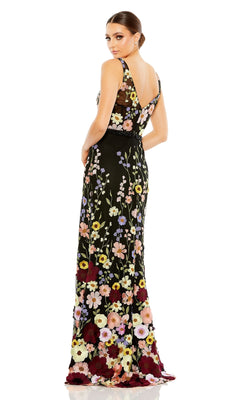 Woman in the Mac Duggal 68200 Floral Long Black Formal Dress stands looking over her shoulder against a white background.