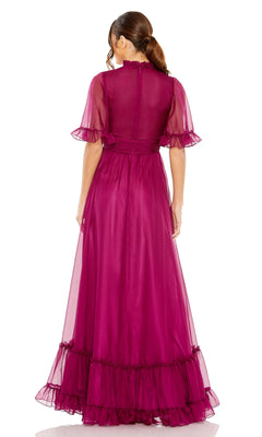 Woman shown from the back wearing the Mac Duggal 68229 short sleeve long formal dress in sheer magenta, featuring a floor-length design with ruffled hem and sleeves.