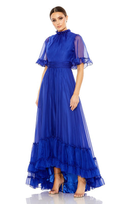 A woman stands against a white background wearing the Mac Duggal 68229, a royal blue short sleeve long formal dress featuring a high neck, ruffled hem, sheer sleeves, and an elegant a-line silhouette.