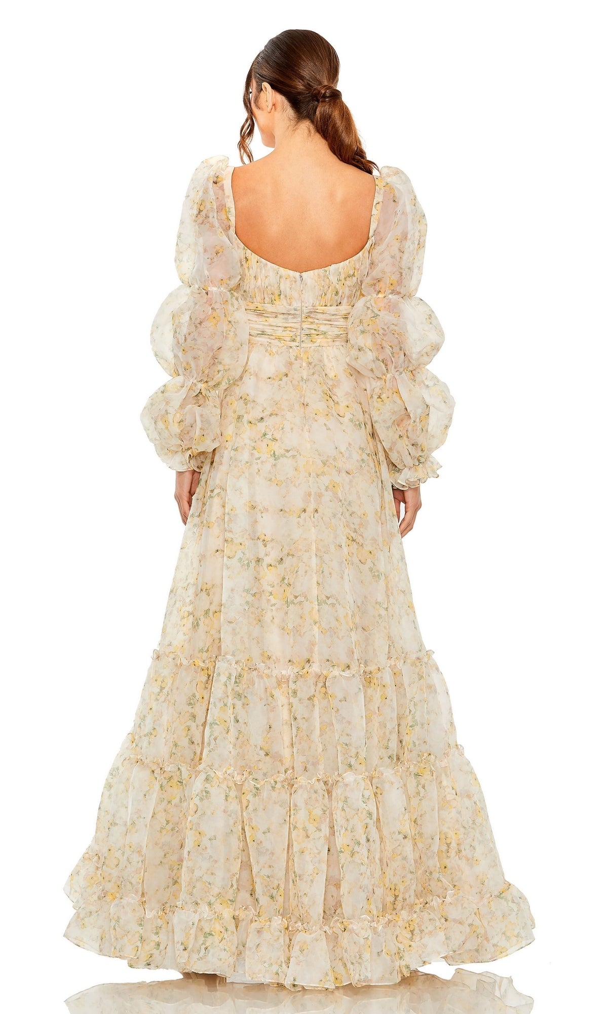 Woman facing away wears the Long Formal Dress 68288 by Mac Duggal, featuring a floral print, puffy sleeves, low back, and ruched empire waist. Her low ponytail enhances the elegant style of this formal A-line gown.