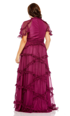A woman faces away, wearing the Long Plus-Size Prom Dress 68424 by Mac Duggal—a floor-length magenta ruffle tiered dress with sheer fabric, short sleeves, and an elegant A-line silhouette.