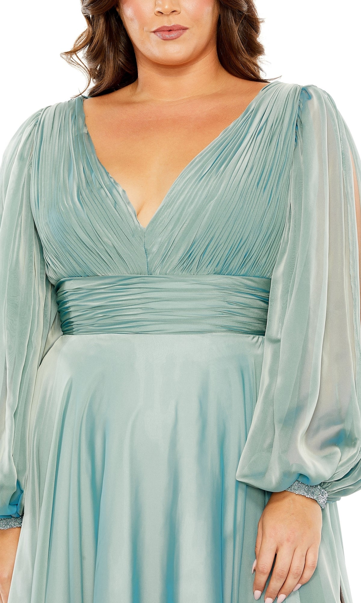 A woman wearing the Long Plus-Size Formal Dress 68431 by Mac Duggal—a light blue, pleated A-line gown with a V-neck, long sheer sleeves, and a fitted waist.