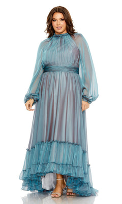 A woman stands against a white background wearing the Long Plus-Size Prom Dress 68434 by Mac Duggal, a teal formal gown featuring sheer sleeves and a ruffle hem.