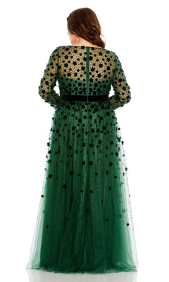 A woman faces away, wearing the Long Plus-Size Prom Dress 68440 by Mac Duggal—a floor-length green gown with sheer sleeves and a floral appliqué overlay.