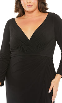 A person wearing the Long Plus-Size Formal Dress 68442 by Mac Duggal—a fitted black gown with a V-neckline and gathered fabric details at the waist and bust.