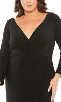 A person wearing the Long Plus-Size Formal Dress 68442 by Mac Duggal—a fitted black gown with a V-neckline and gathered fabric details at the waist and bust.