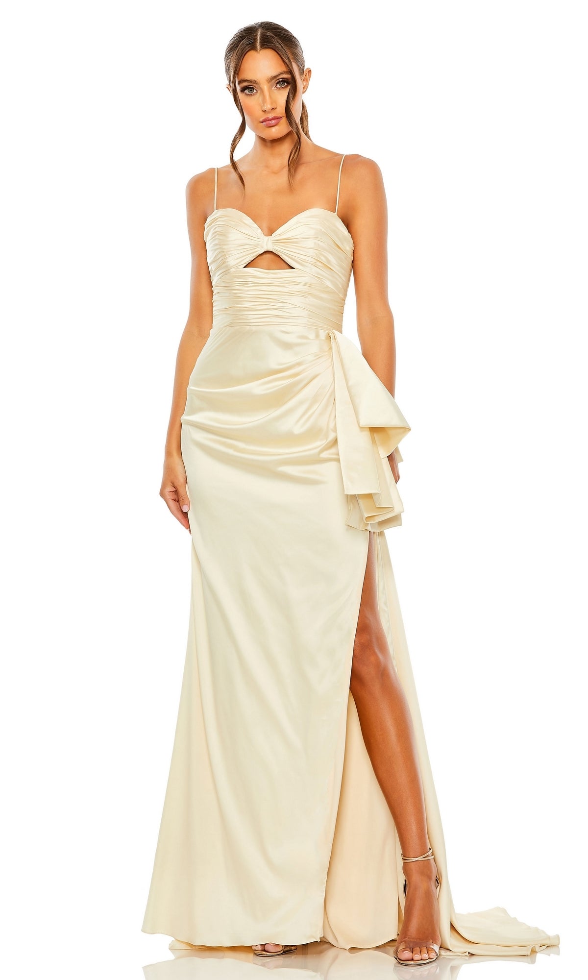 A woman wears the Long Formal Dress 68450 by Mac Duggal, a cream satin gown with a ruched sweetheart bodice, spaghetti straps, front cutout, side slit, and draped waist detail, standing against a white background.