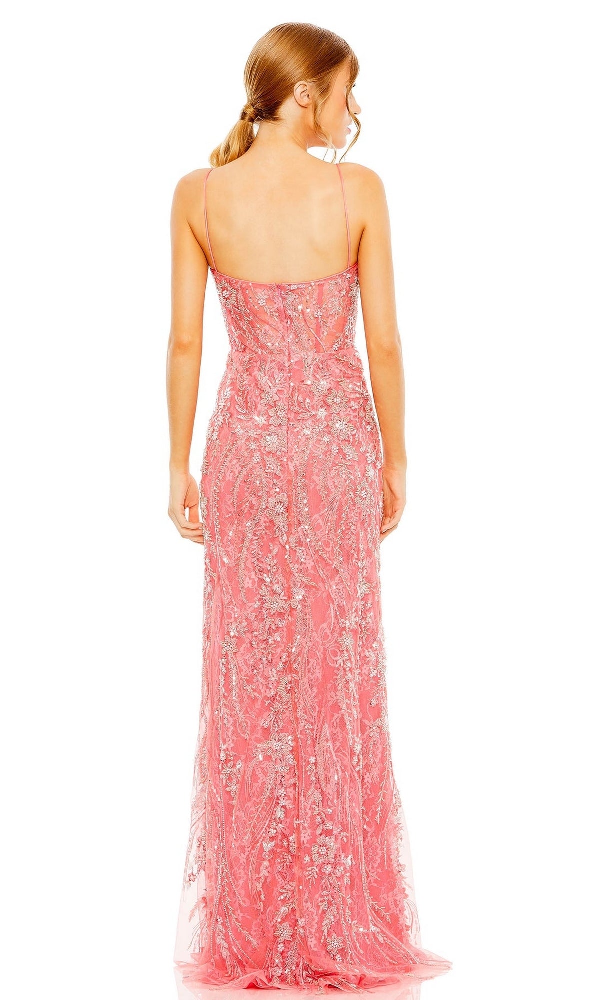 A woman with light brown hair in a low ponytail is shown from the back wearing the Long Formal Dress 68511 by Mac Duggal, a floor-length coral pink gown with silver sequin embellishments.