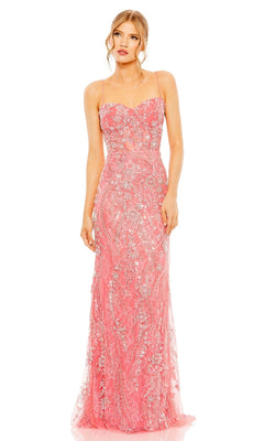 A woman wearing the Long Formal Dress 68511 by Mac Duggal in coral pink with a sweetheart neckline and silver floral embellishments stands against a plain white background.