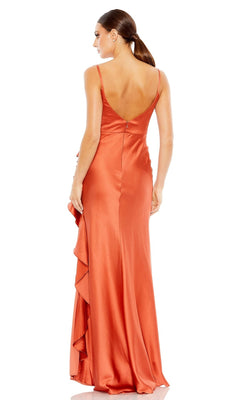 Woman in the Long Formal Dress 68551 by Mac Duggal, a sleeveless orange satin gown with a deep V-back and ruffle detail, standing and facing away.
