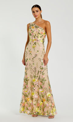 Woman wearing the Mac Duggal 68606 Yellow Floral-Print Formal Dress, featuring a long, elegant silhouette and colorful floral details, standing against a plain white background.