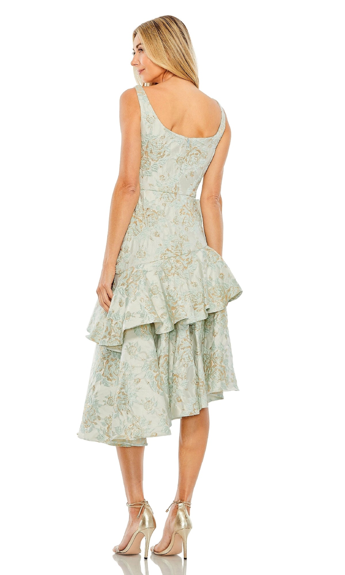 A woman wearing the Mac Duggal 68613 French Blue Wedding Guest Dress—a sleeveless, ruffled midi with a layered skirt—paired with metallic high heels, seen from the back.