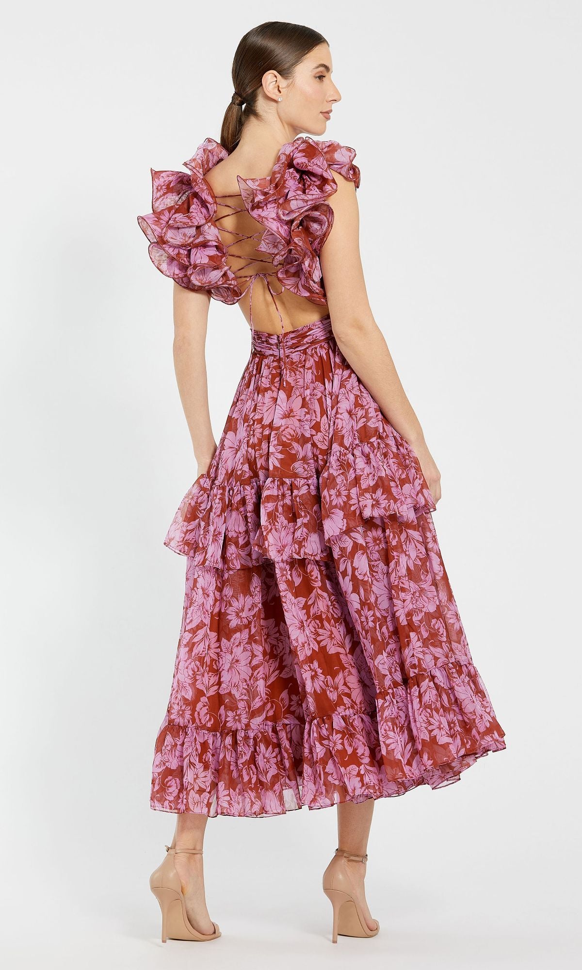 Woman in profile with hair tied back, wearing the Mac Duggal 68644 Red Floral Print Chiffon Formal Dress featuring a sleeveless design, open lace-up back, and tiered A-line skirt.
