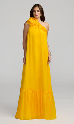A woman stands against a plain light background wearing the Mac Duggal 68757 Long Formal Dress in Sunshine, a floor-length, one-shoulder chiffon gown featuring a ruffled neckline and gathered hem.